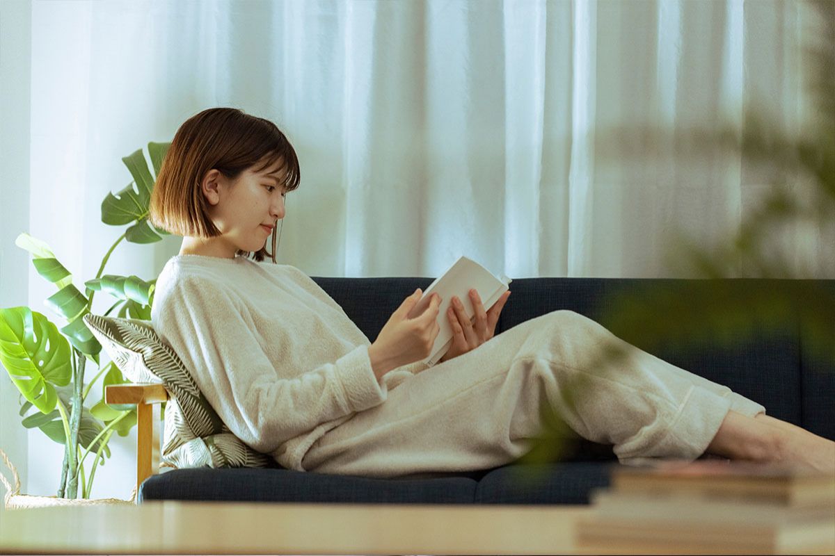 A young woman reading a book